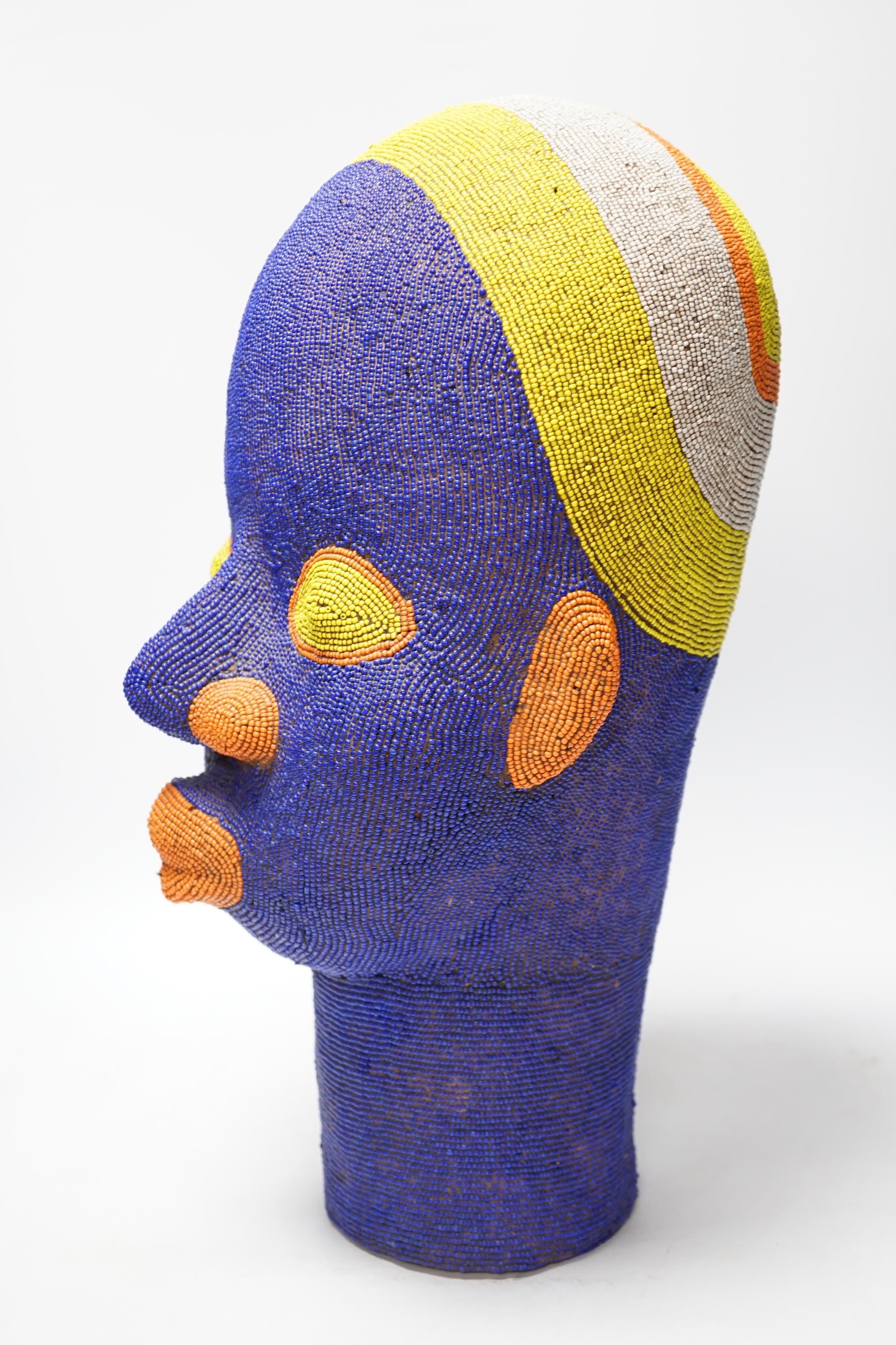 A large African clay multicoloured beadwork head, 48cm high